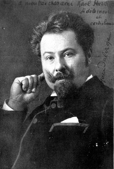 Portrait d'Émile Jaques-Dalcroze, la main au visage, avec une dédicace manuscrite.